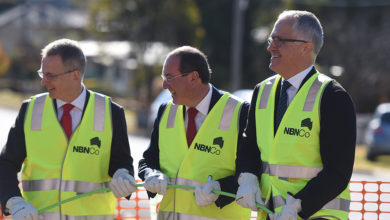 Then-Federal Minister for Communications Malcolm Turnbull (right) lends a hand rolling out NBN fibre during a visit to an NBN rollout site in Queanbeyan, near Canberra, Wednesday, June 3, 2015. AAP Image/Lukas Coch