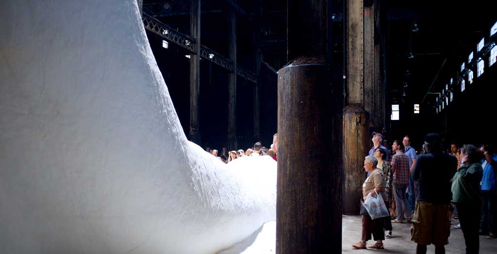 An inhuman scale: Punters take a close up look at 'A Subtlety'.