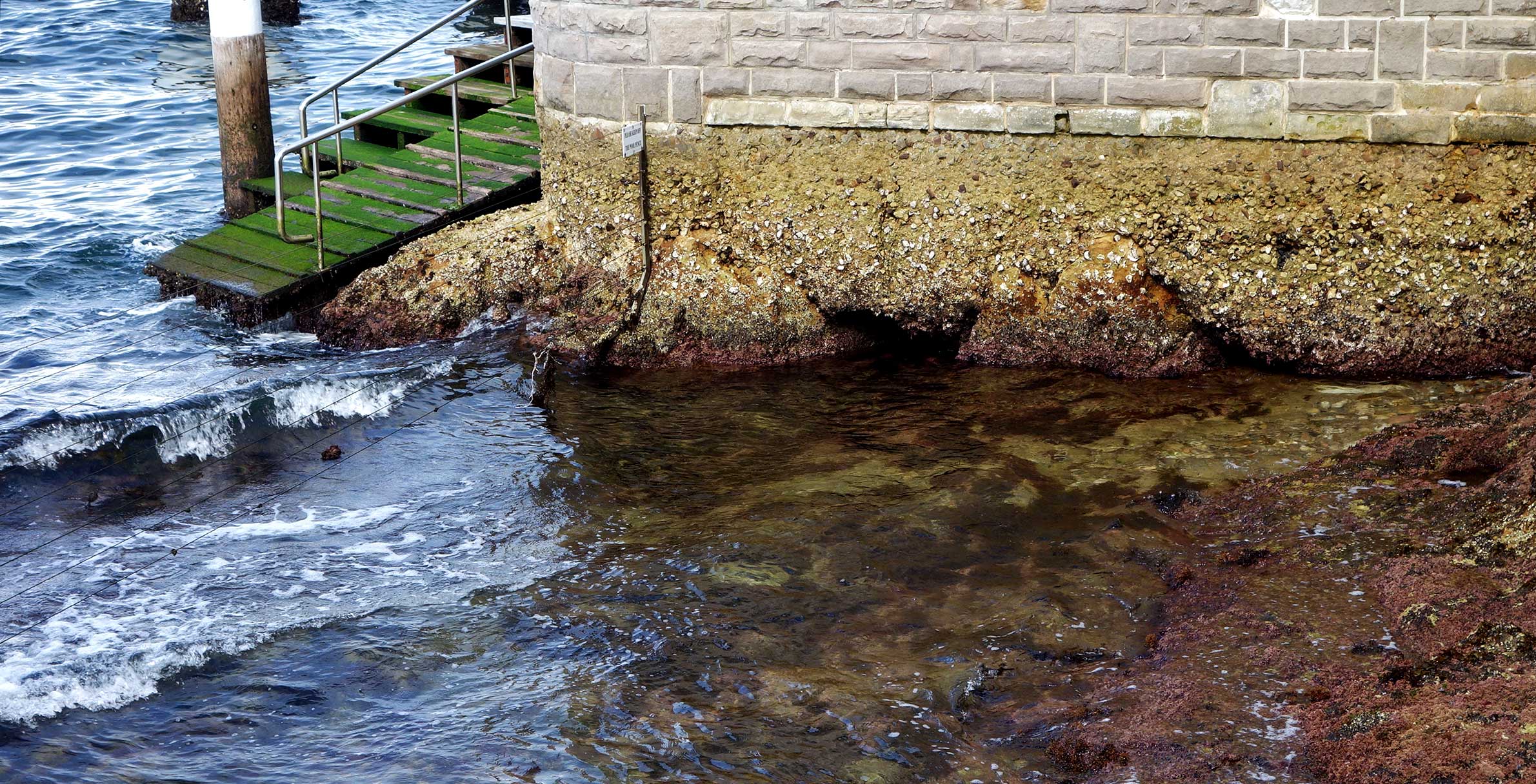 An older harbour pool at low tide.