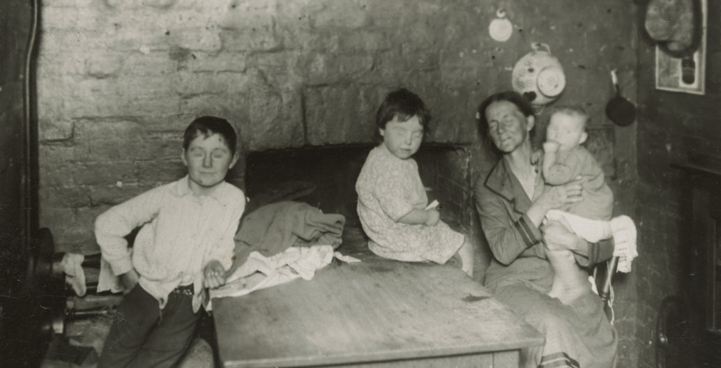 Carlton [Kitchen interior with woman and three children]. Image: SLV