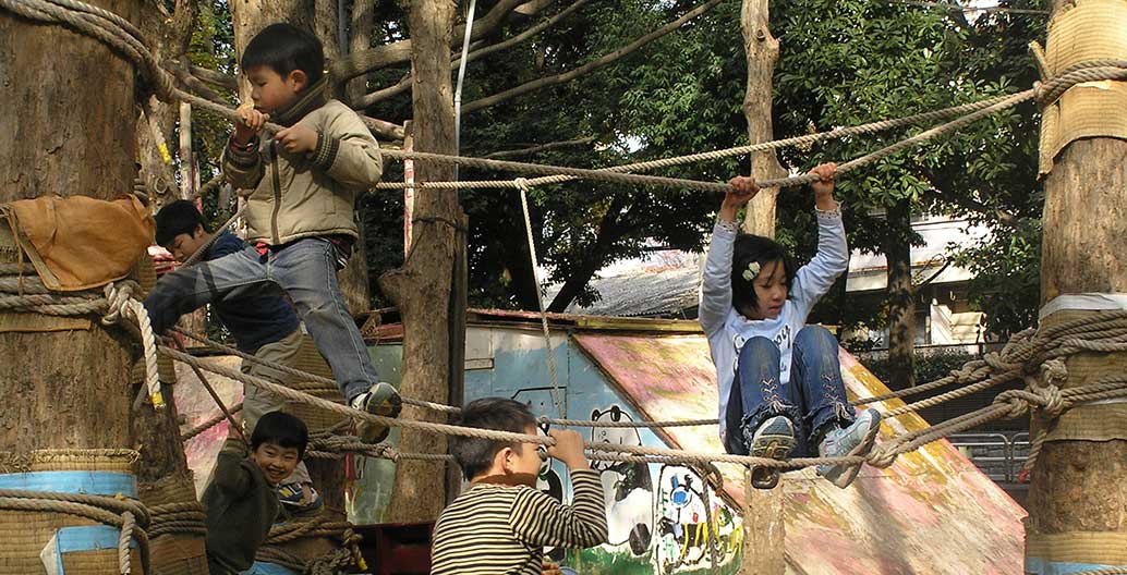 Japanese children playing unsupervised in city adventure play parks