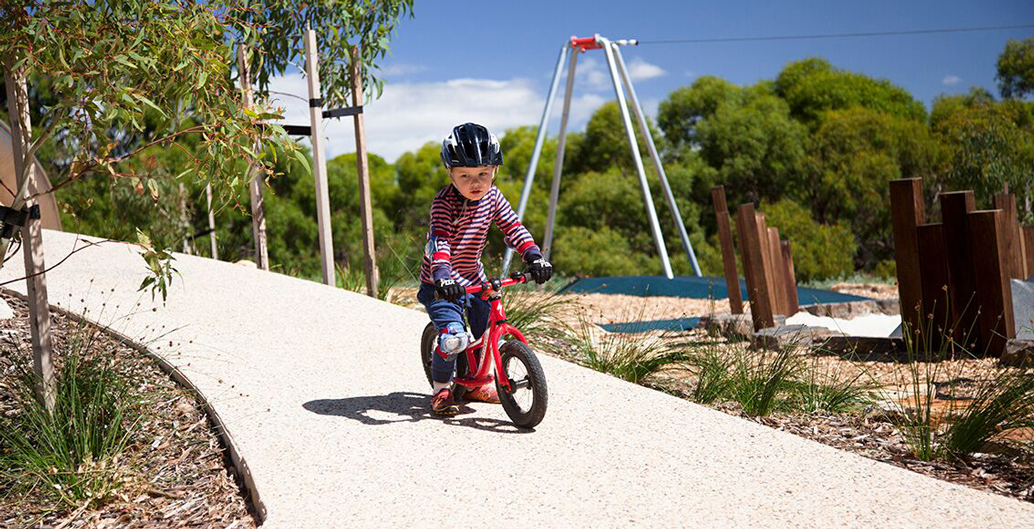 A little tyke runs the park-loop.