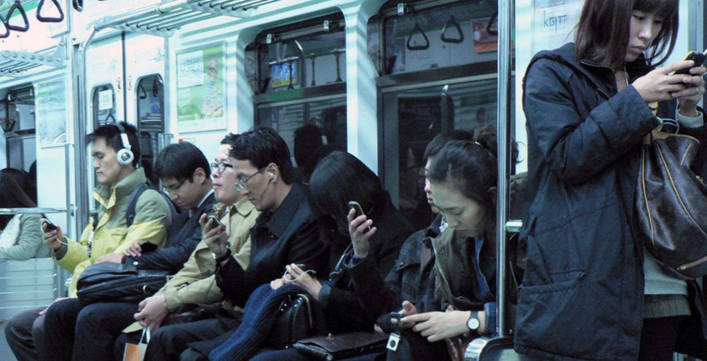 Much of our life in public space is now spent immersed in glowing screens. Photo: Marc Smith