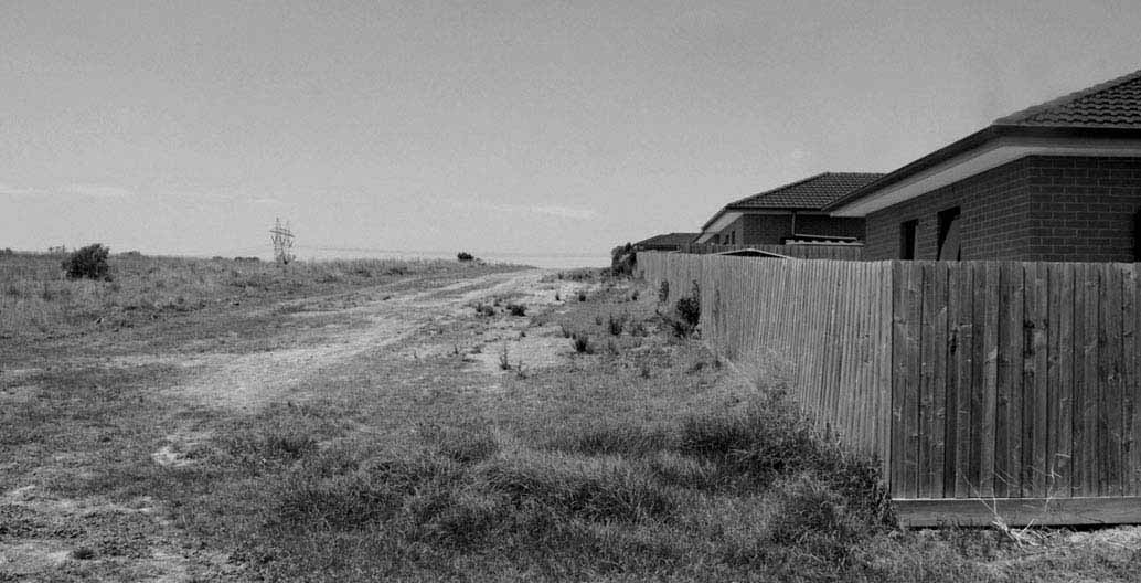 Suburban fences adjoin public land