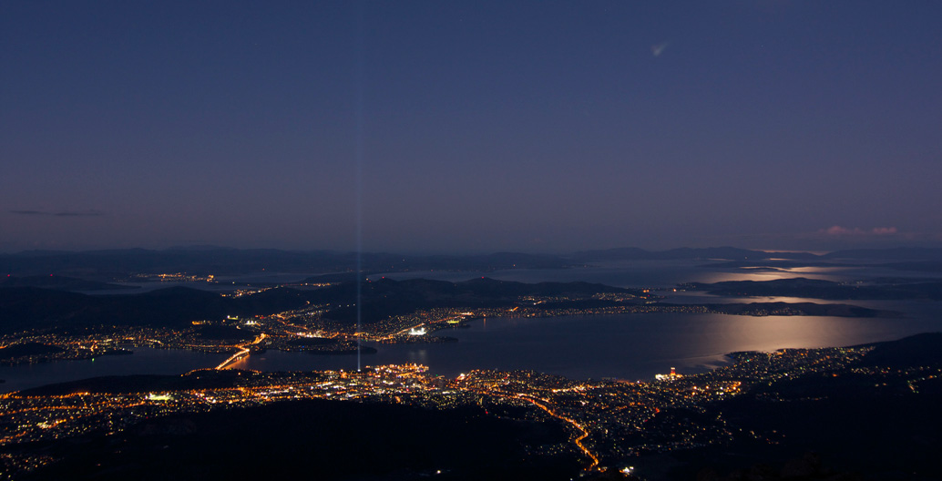 Ryoji Ikeda's Spectra beams light 15 kilometres into the sky during Hobart's Dark Mofo. Credit: Christopher Neugebauer, Flickr: CC