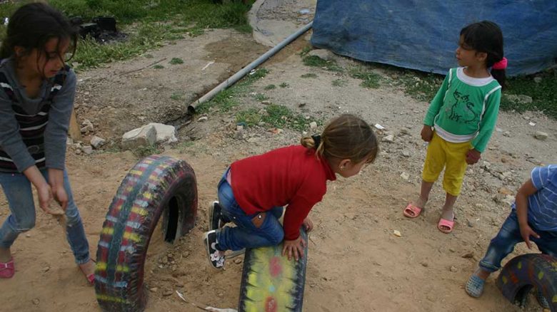 Children play in the new, improvised playground.