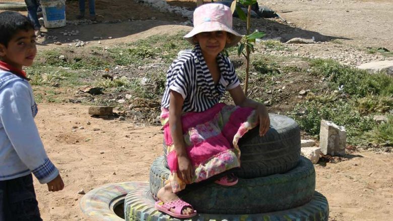 Children play in the new, improvised playground.