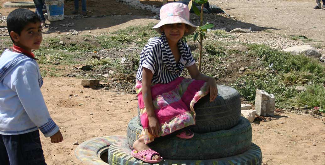 Children play in the new, improvised playground.