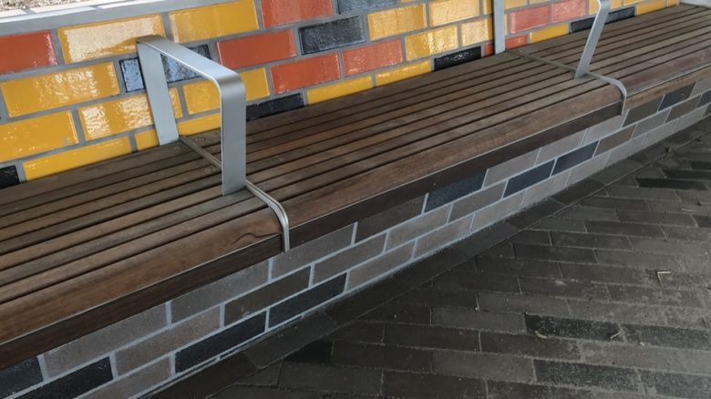 There is detailed attention to the materials of public space furniture beneath the sky rail.