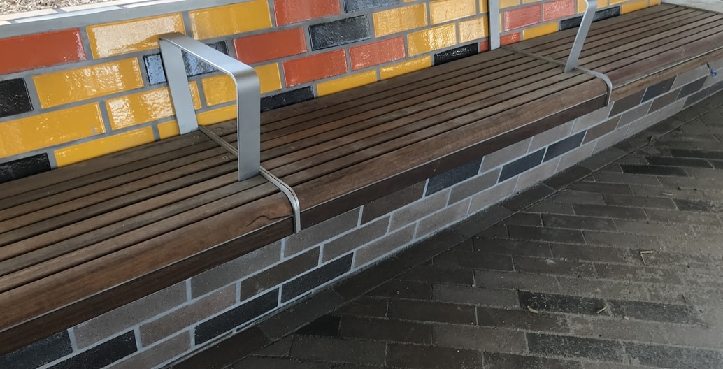 There is detailed attention to the materials of public space furniture beneath the sky rail.