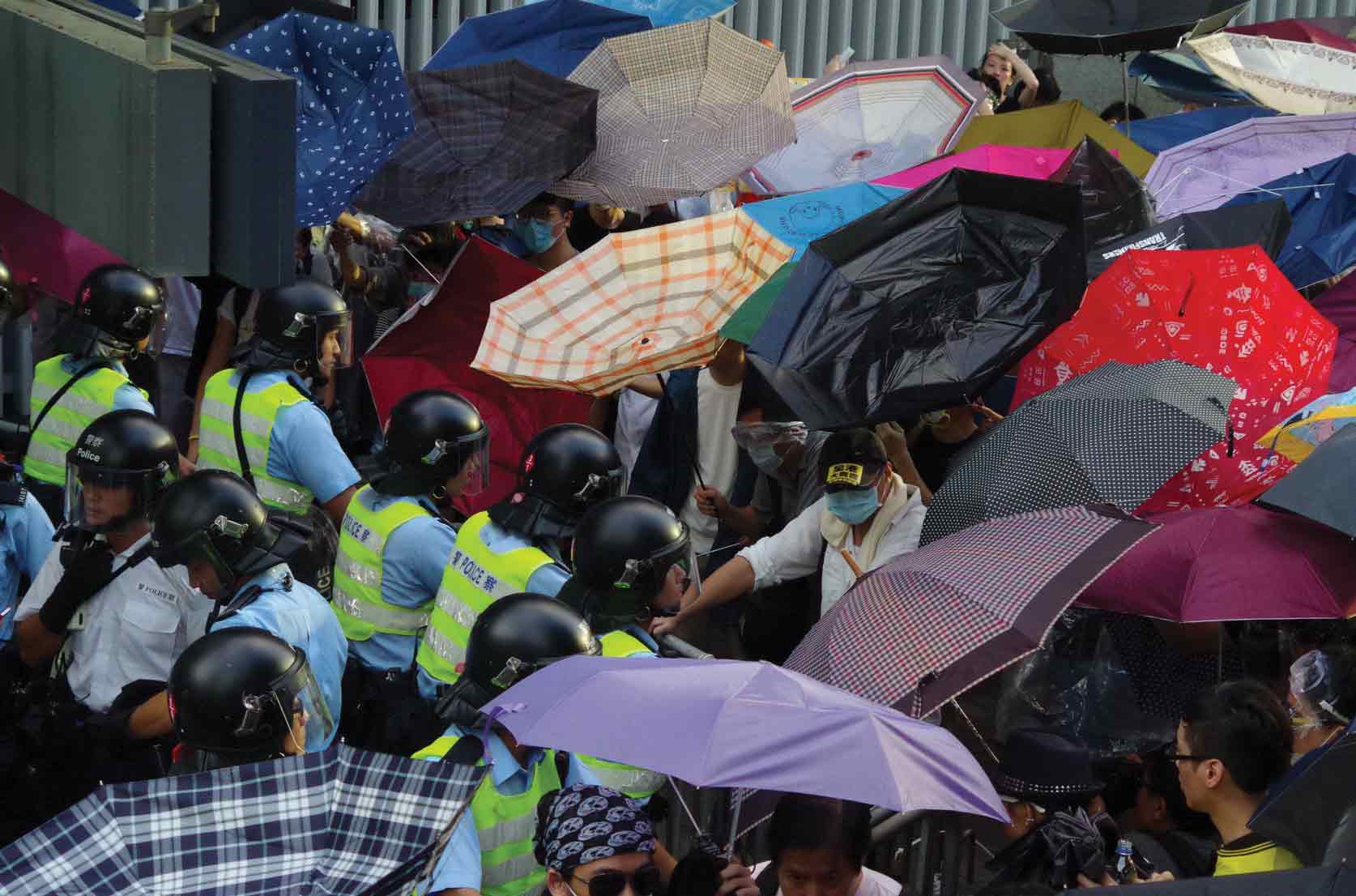 Protesters using umbrellas as shields from the police and later, tear gas, 2014. Photo: FX Pasquier