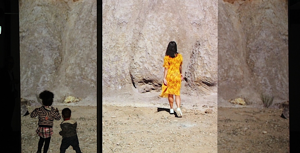 Amrita Hepi on screen viewed by audience children. Multi-screen video installation Movement of Place, at TCL, Adelaide. Image supplied