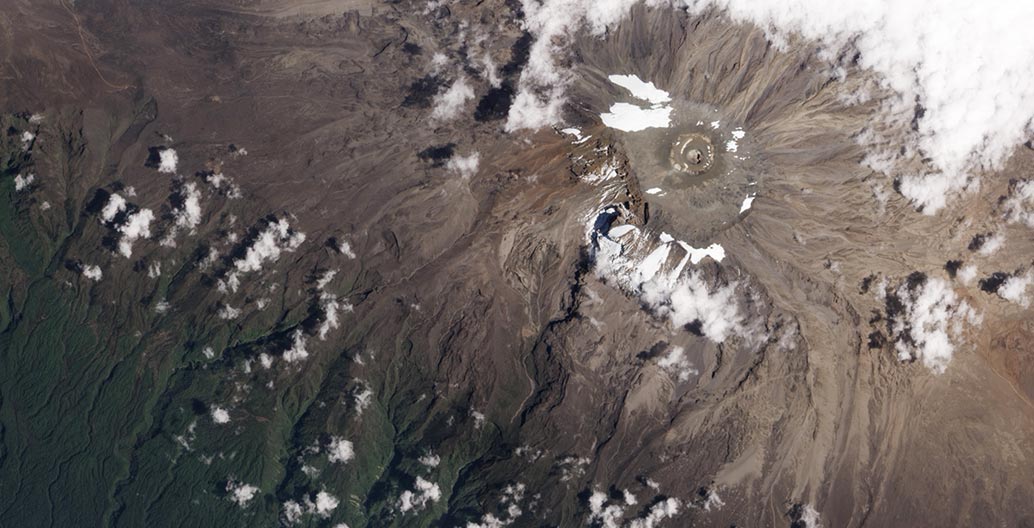 The remnants of Mount Kilimanjaro's fabled fields of snow and ice, as seen from space in 2012. Image: NASA Earth Observatory