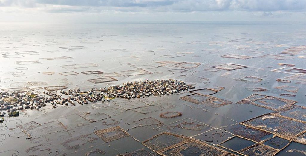 Built by the Tofinu, the city of Ganvie floats on Lake Nokoué surrounded by a radiating reef system of 12,000 acadja fish pens. Photo: © Iwan Baan