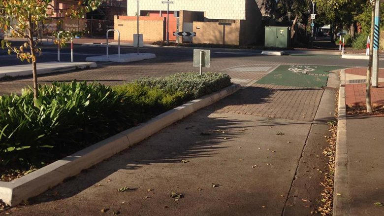 Frome Road, Adelaide, utilises a planted barrier between vehicular and cycling lanes. Image: Philip Mallis