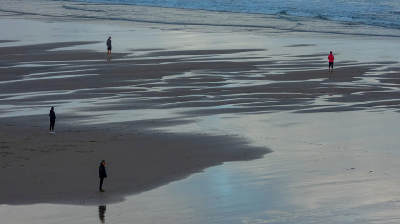 Social distancing, seen here on a British beach, has not been taken seriously by enough Australians. Image: Nick Fewings.