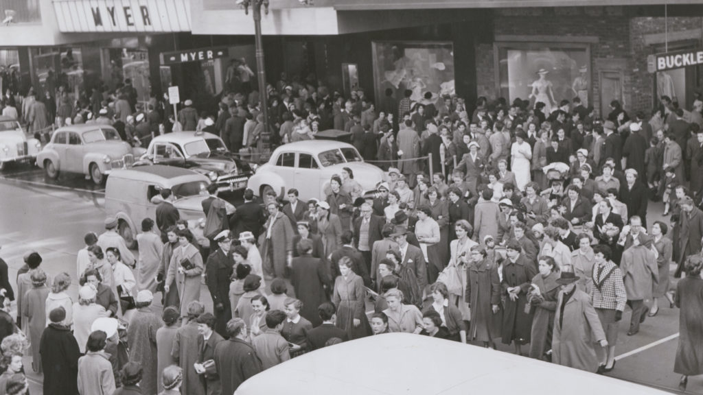 Shoppers in Melbourne's Bourke Street battle with cars for street space, c.1948. Image: State Library of Victoria archives