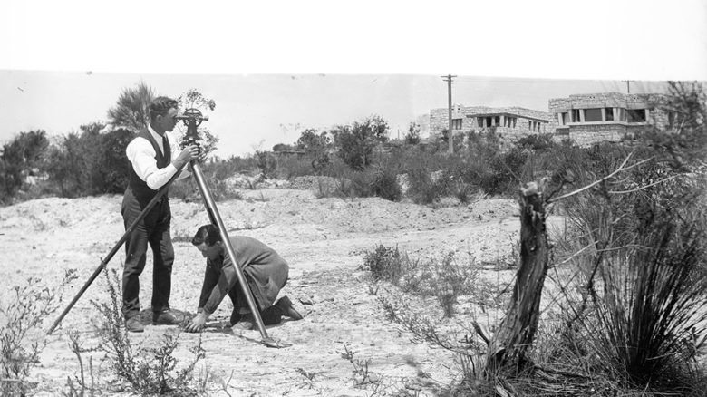 View of Castlecrag houses + surveyor with Theodolite. Walter Burleigh Griffin circa 1920-23. (c) National Library of Australia.